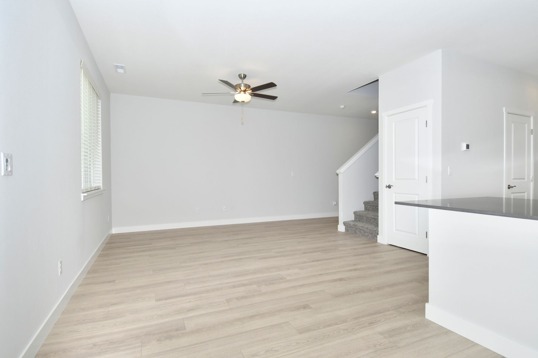 The family room is spacious with a ceiling fan.