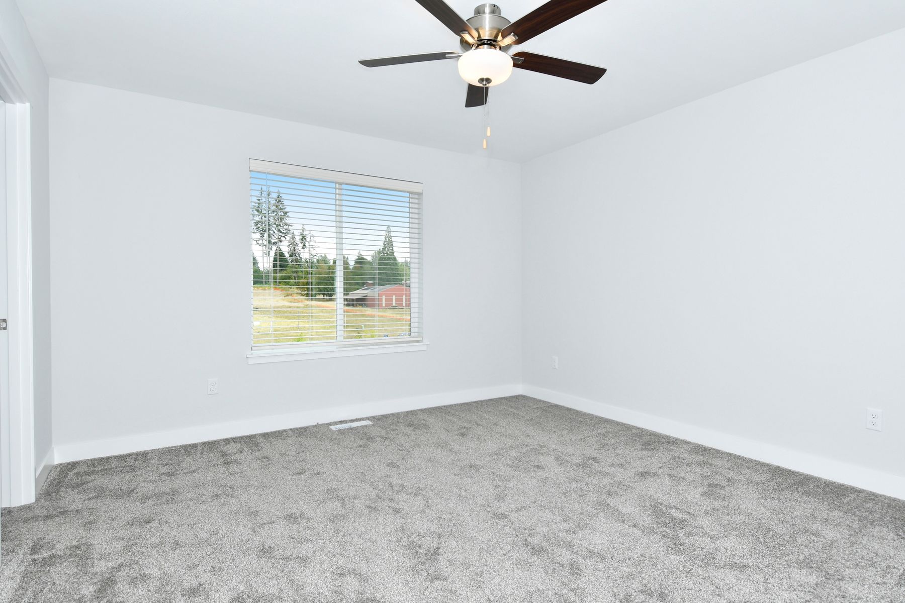 The master bedroom is spacious and has carpet.