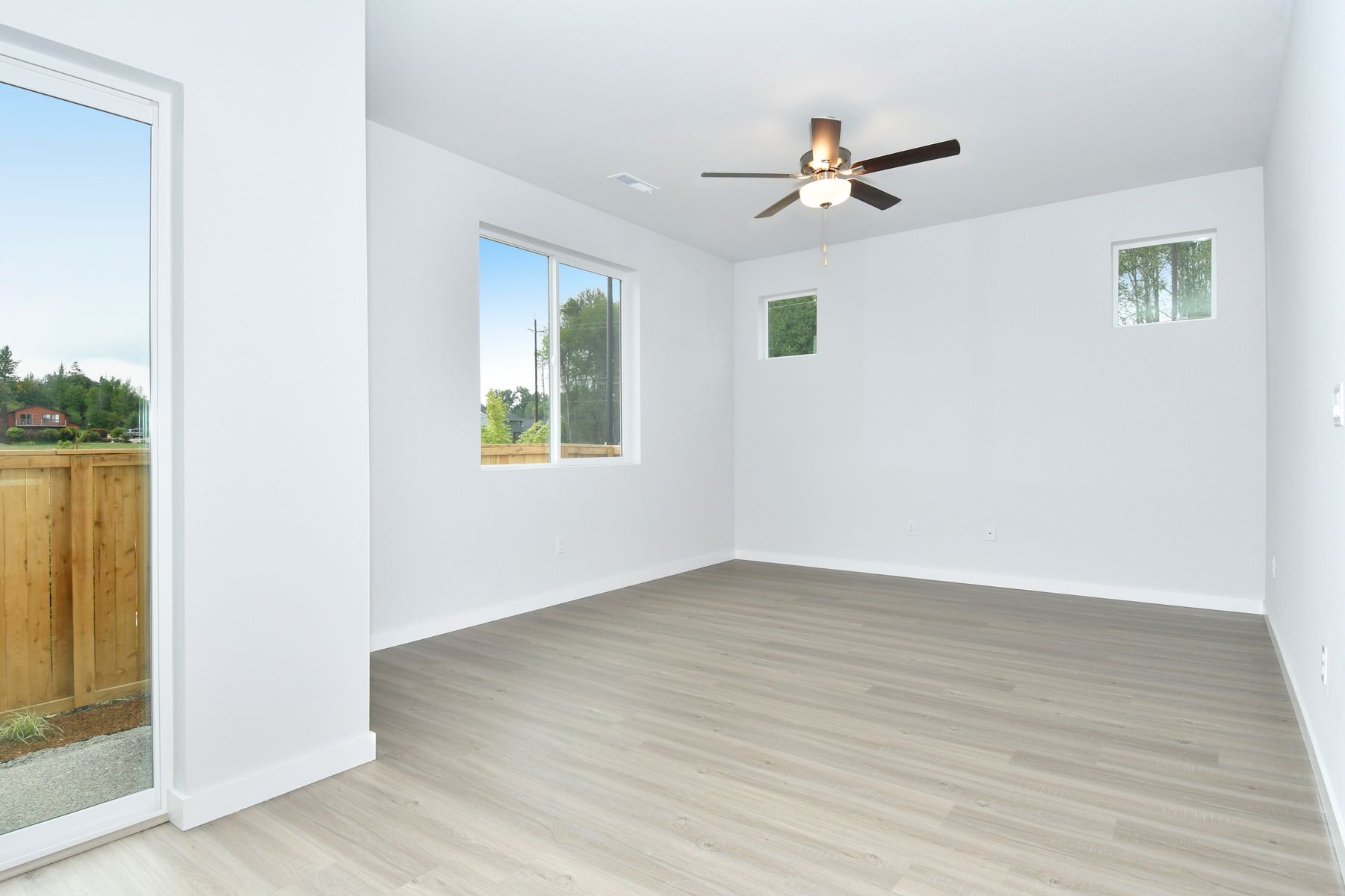 The family room is spacious with a ceiling fan.