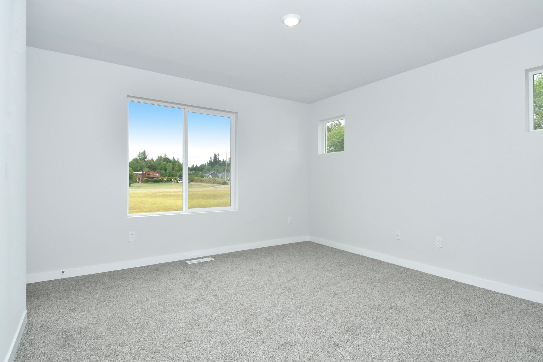 The master bedroom is spacious and has carpet.