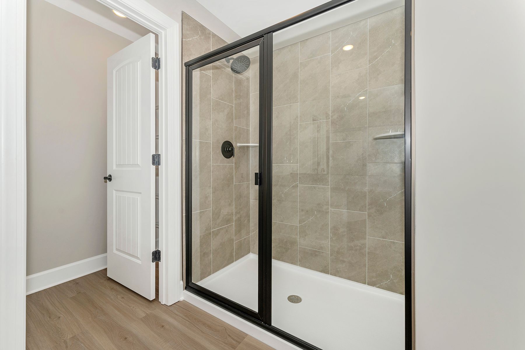 This bathroom comes with a glass-enclosed shower.