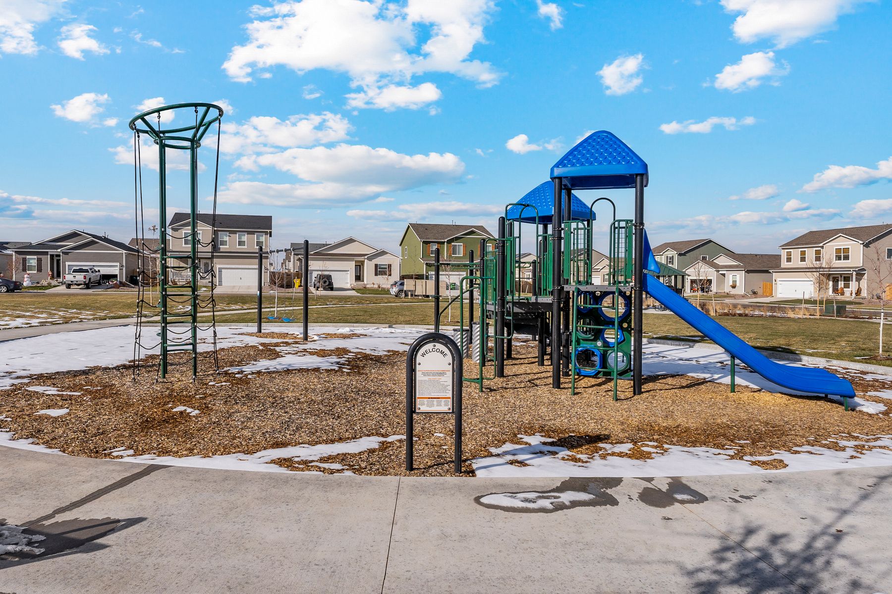 There is a community park with a playground and swing set.