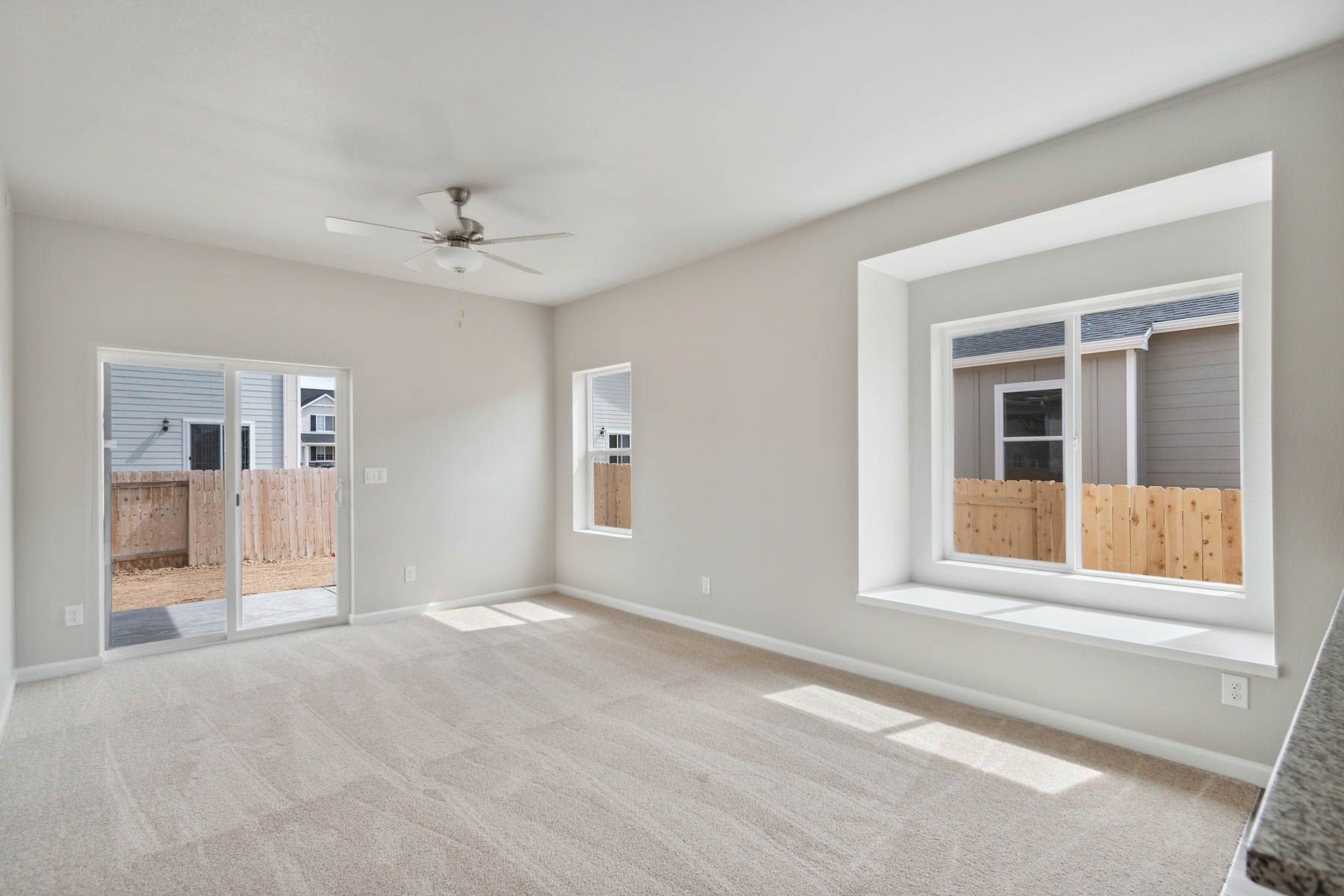 The family room is spacious with a ceiling fan.
