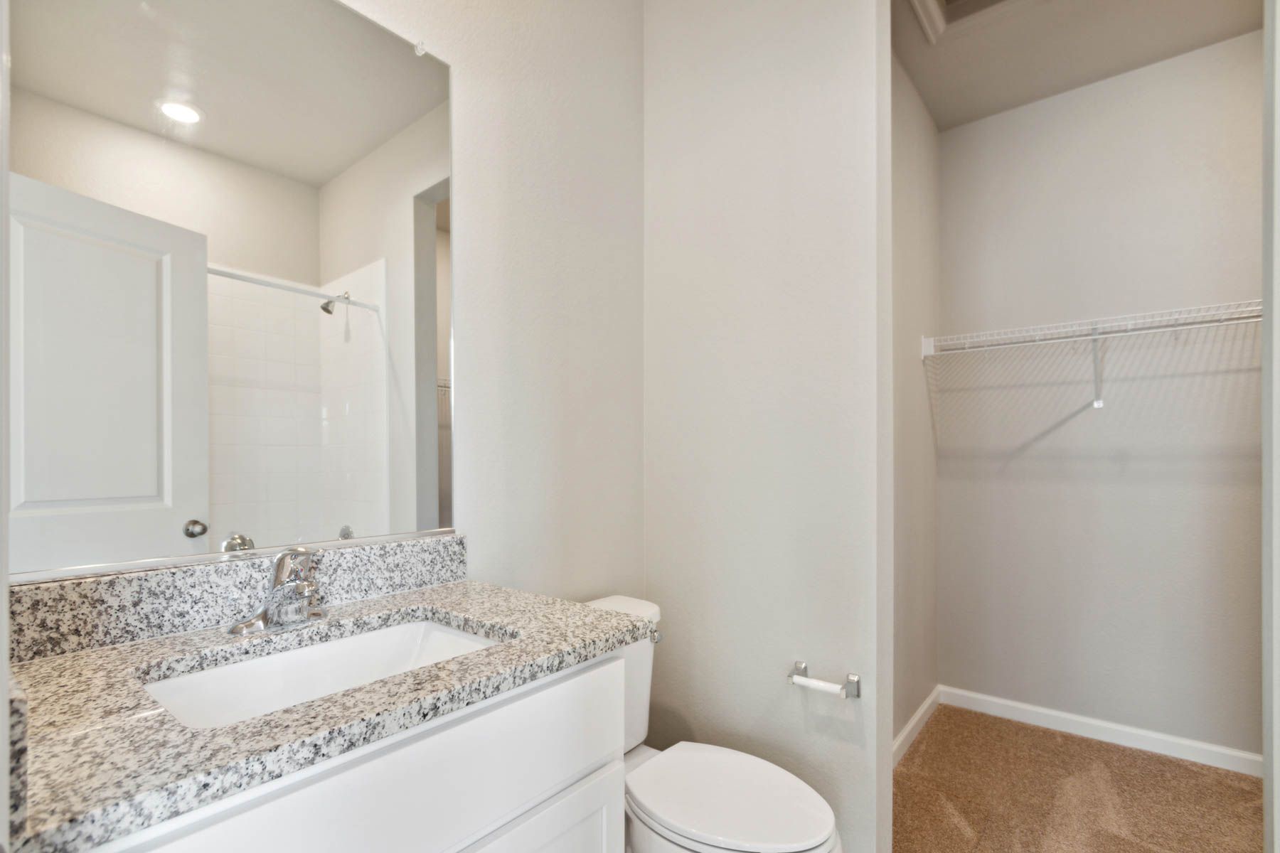 The master bathroom has a vanity and a tub/shower combo.