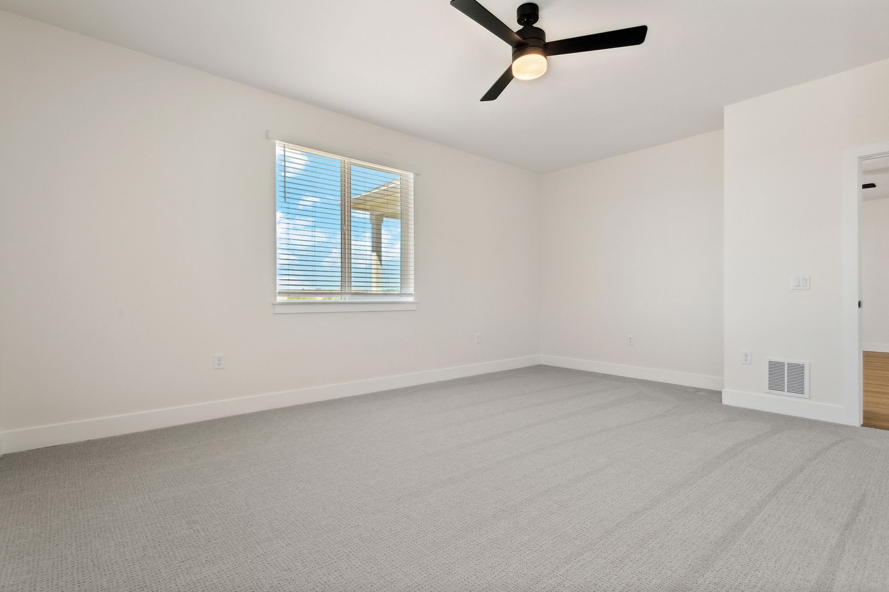 The master bedroom has large windows that let in great, natural light.