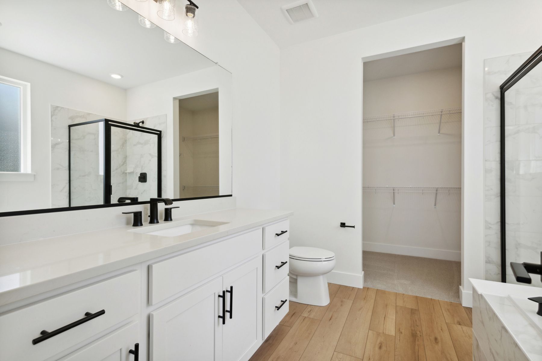 The master bathroom has a large vanity space.