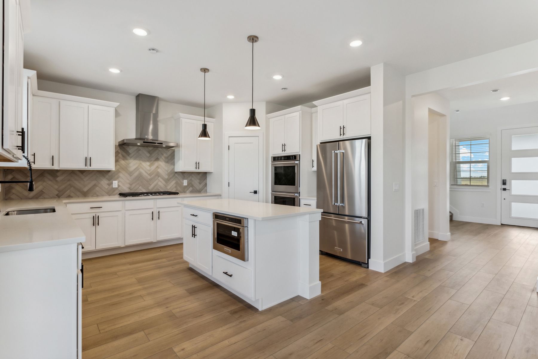 The beautiful kitchen has stainless steel, energy efficient appliances.