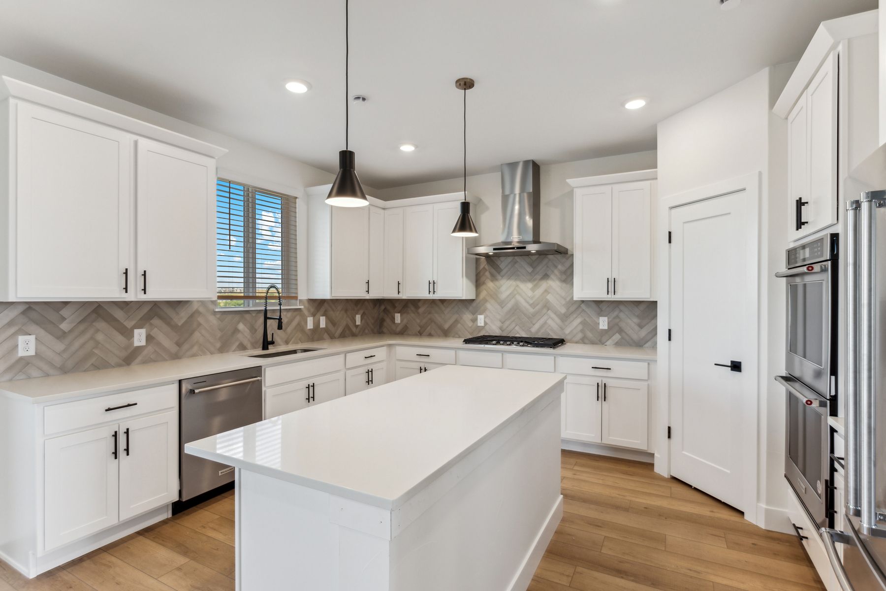 The gorgeous kitchen has beautiful quartz countertops.