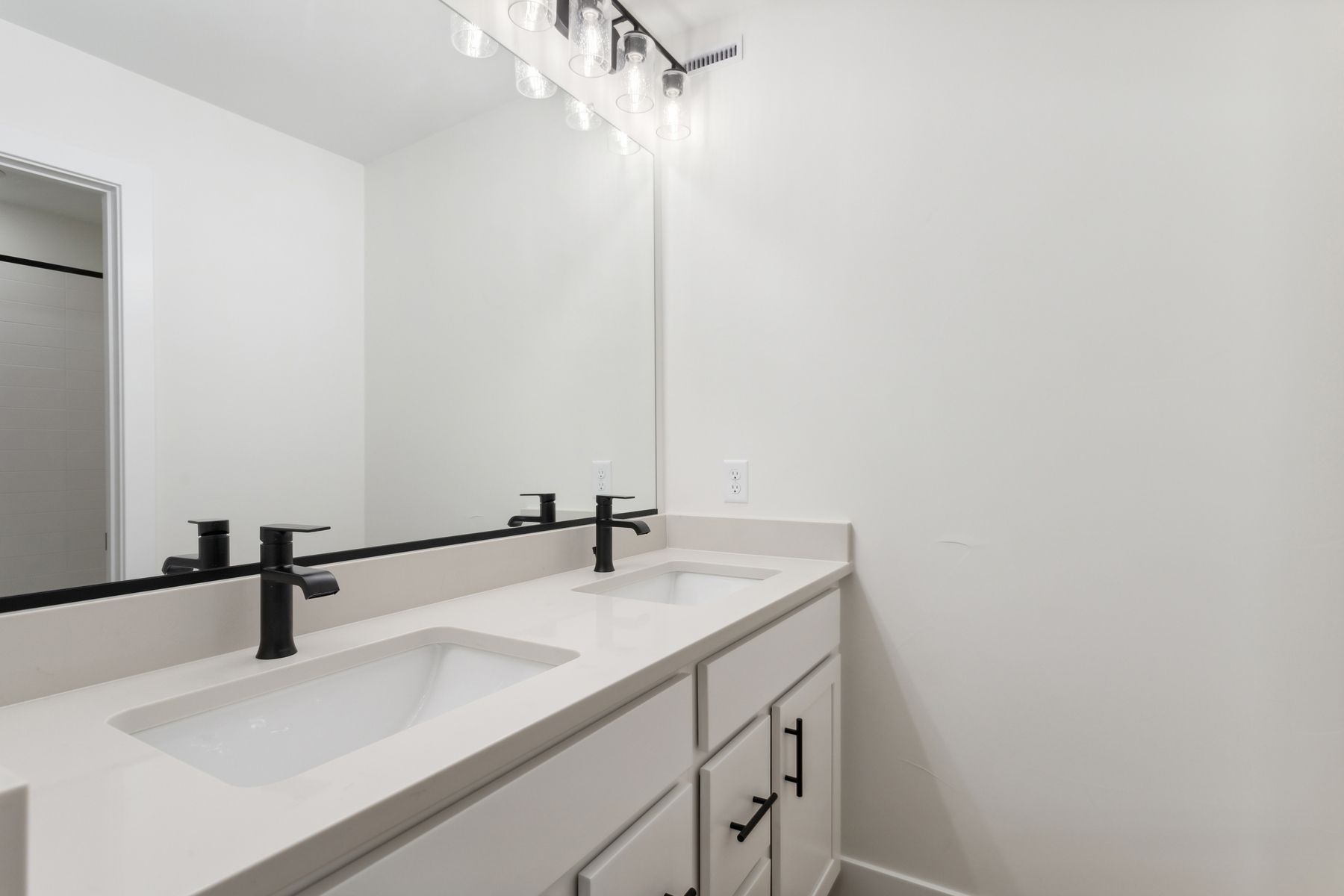 The secondary bathroom has a large vanity with lots of counterspace and a shower-tub combo.