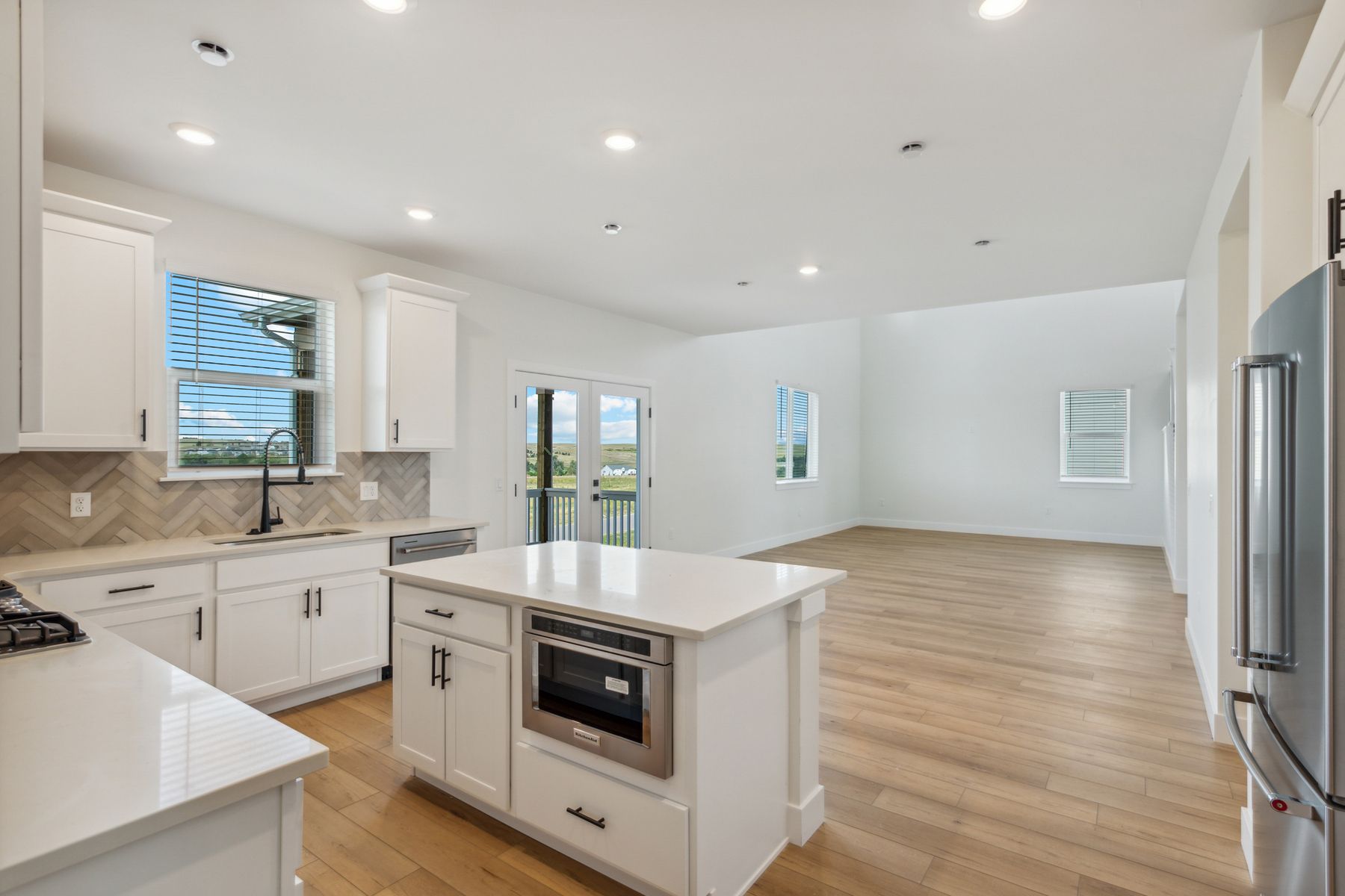The kitchen has sprawling quartz countertops.