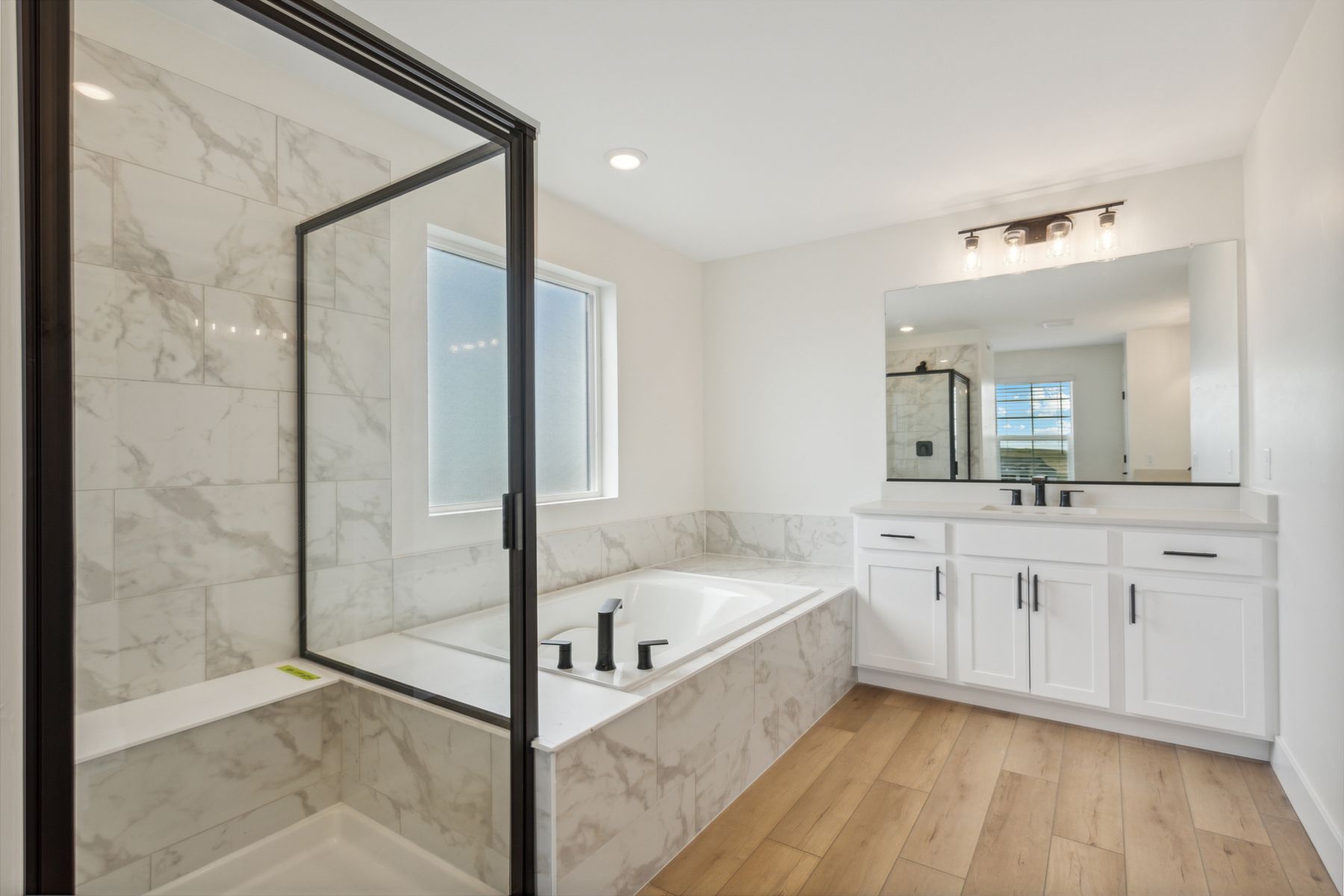 The wonderful master bathroom has a glass, walk-in shower and garden tub.