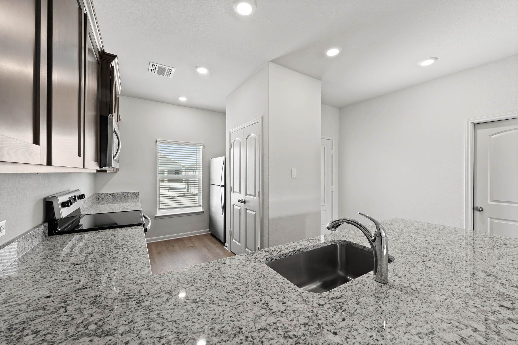 The kitchen of the Driftwood has sprawling granite countertops.