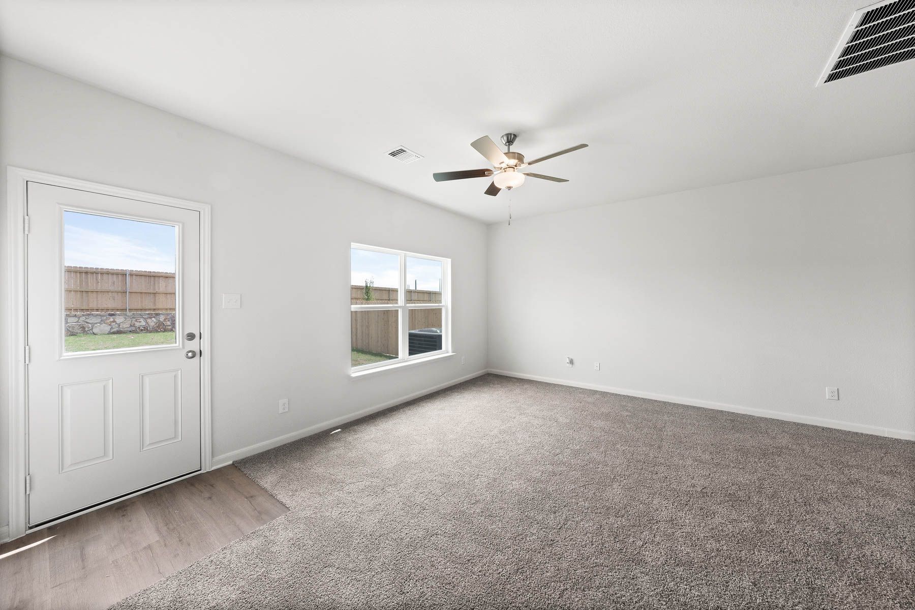 The family room of the Driftwood has a large window that lets in great natural light and backyard views.