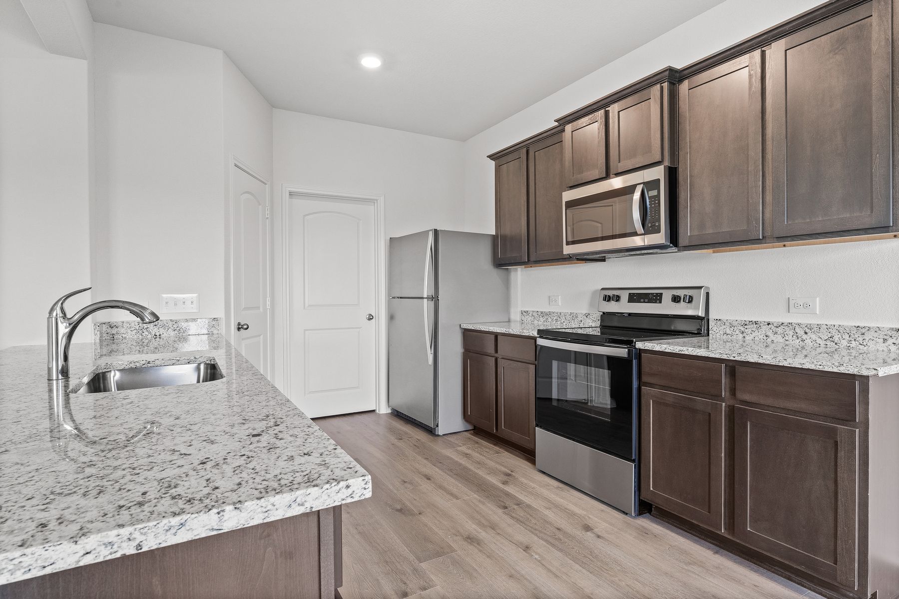 The kitchen of the Cypress has beautiful wood cabinetry.
