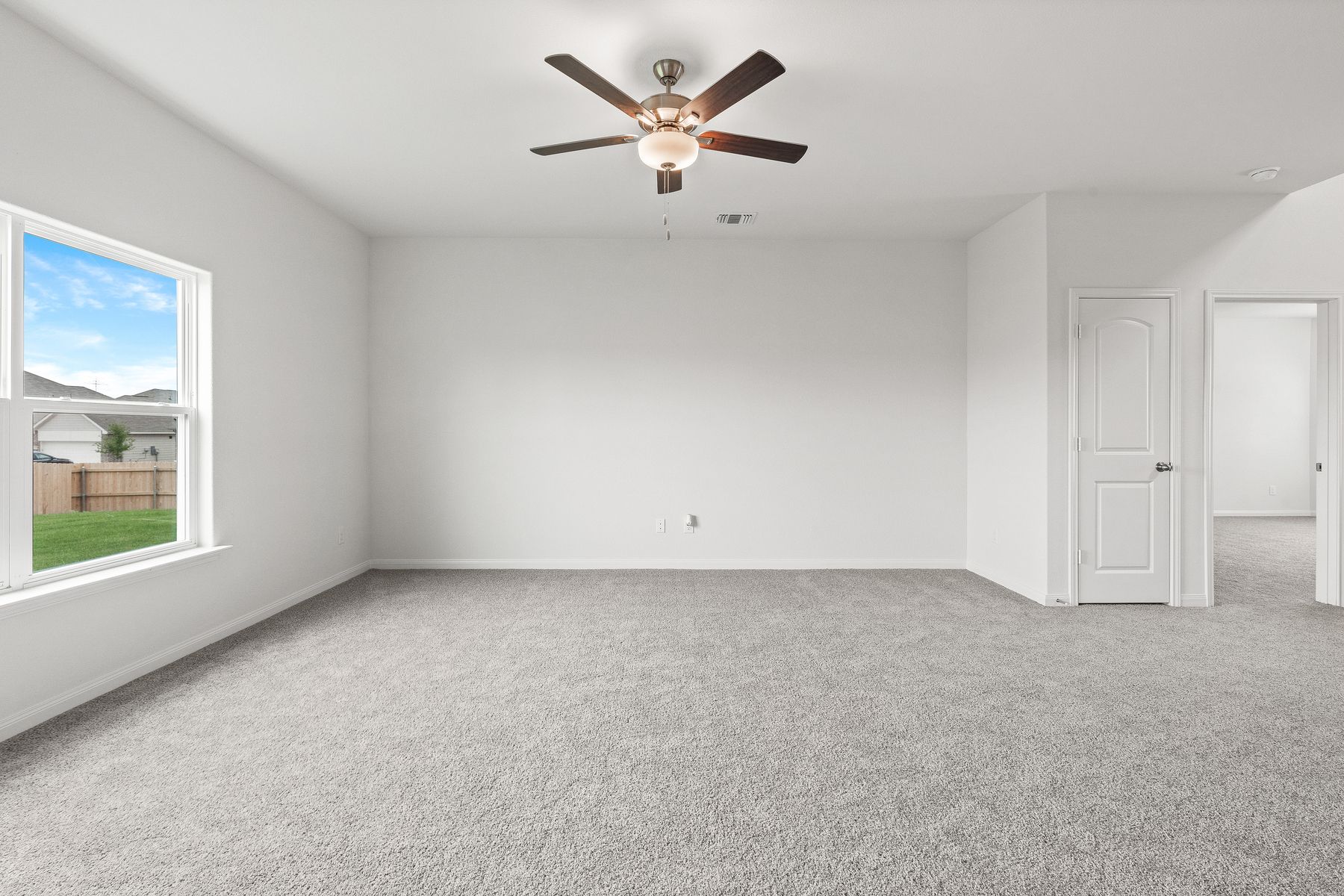 The family room of the Cypress has a large window that lets in great light and backyard views.