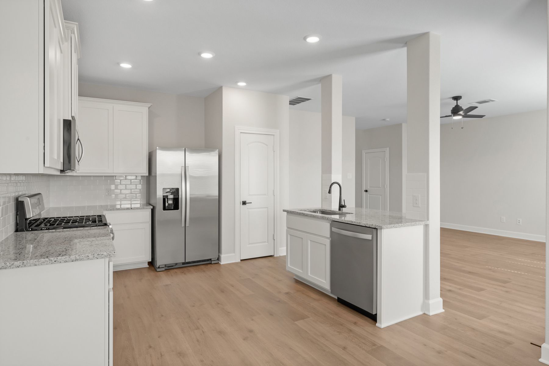 The kitchen looks out to the family room.