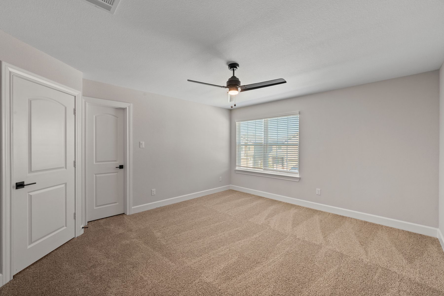 The master bedroom has large windows that let in great, natural light.