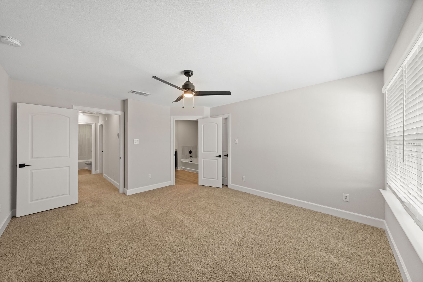 The master suite has a large bedroom, en-suite bathroom and spacious walk-in closet.