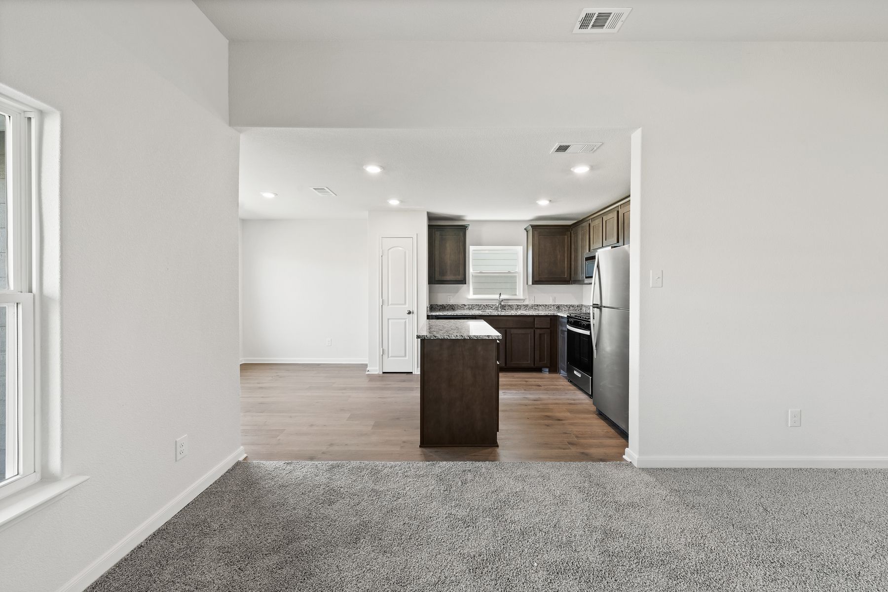 The family room sits right off of the kitchen and dining room creating an open-concept layout.