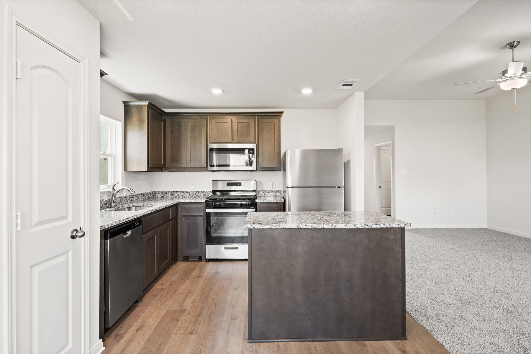 The beautiful kitchen has wood cabinetry.