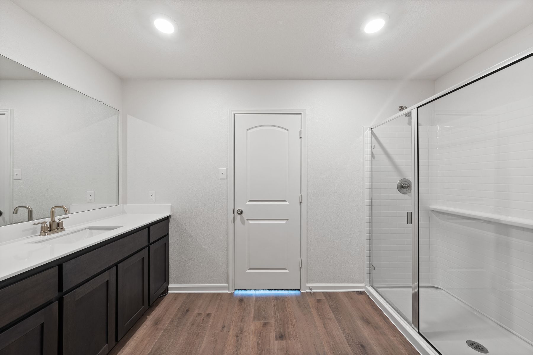 The master bathroom has a glass, walk-in shower.