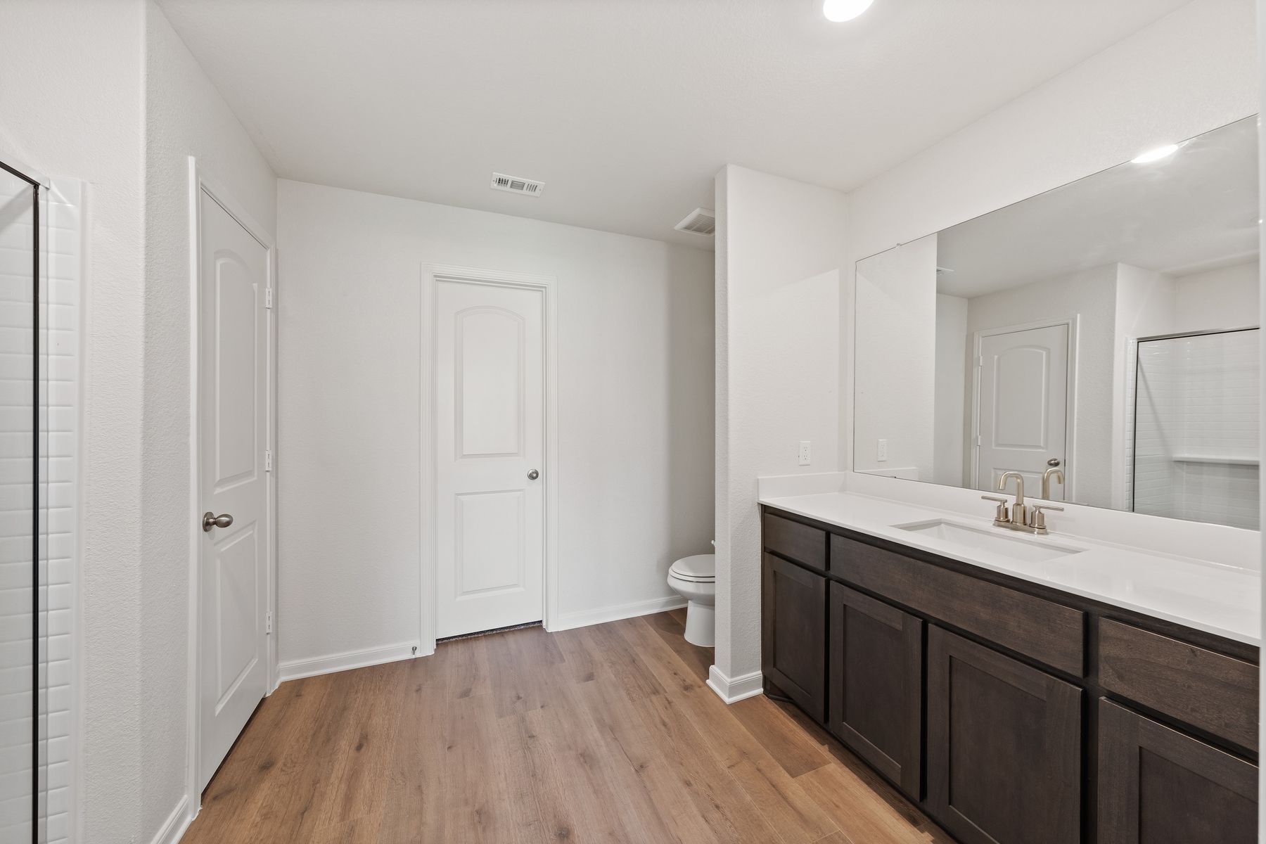 The master bathroom has a large vanity space.