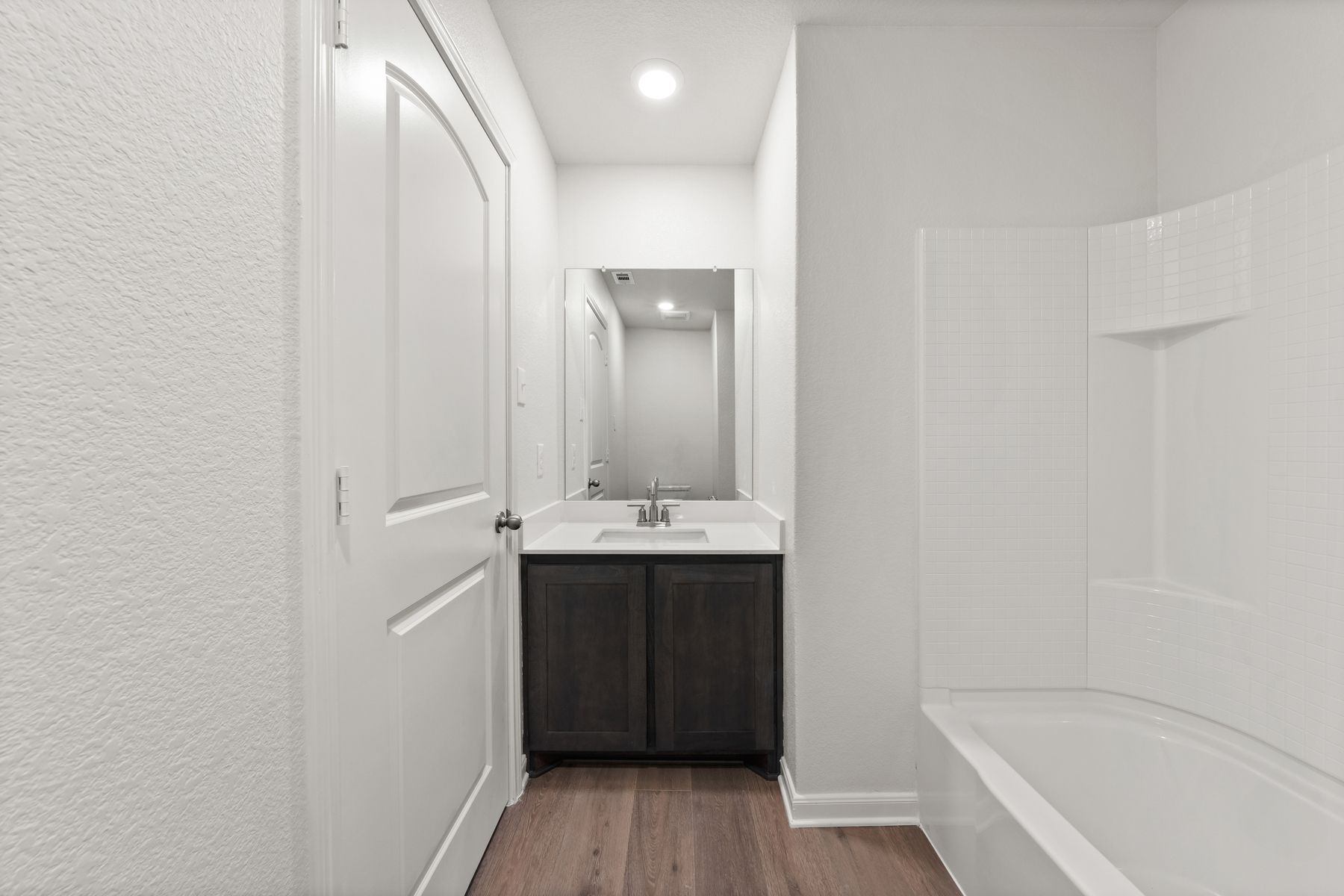 The secondary bathroom has a vanity space.