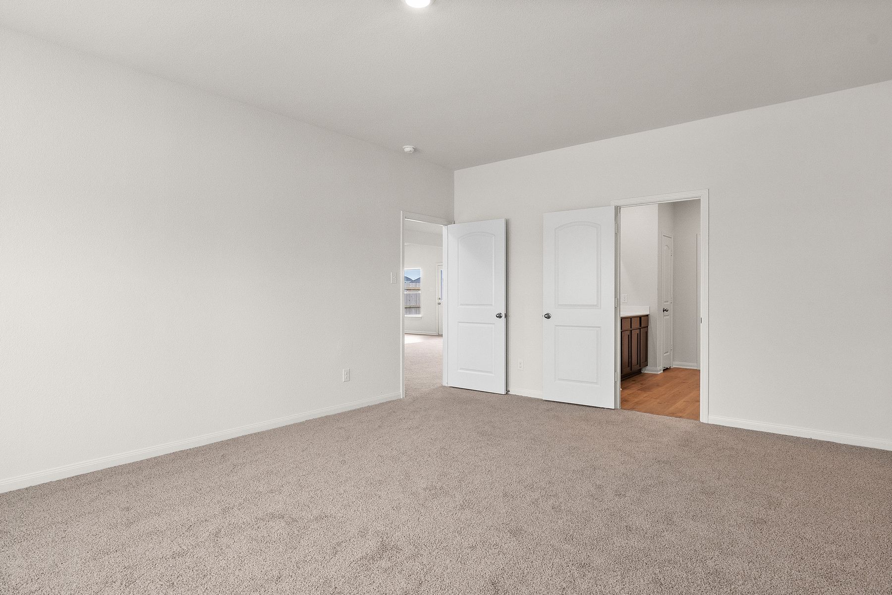 The master bedroom of the Cypress has three large windows that let in great natural light.