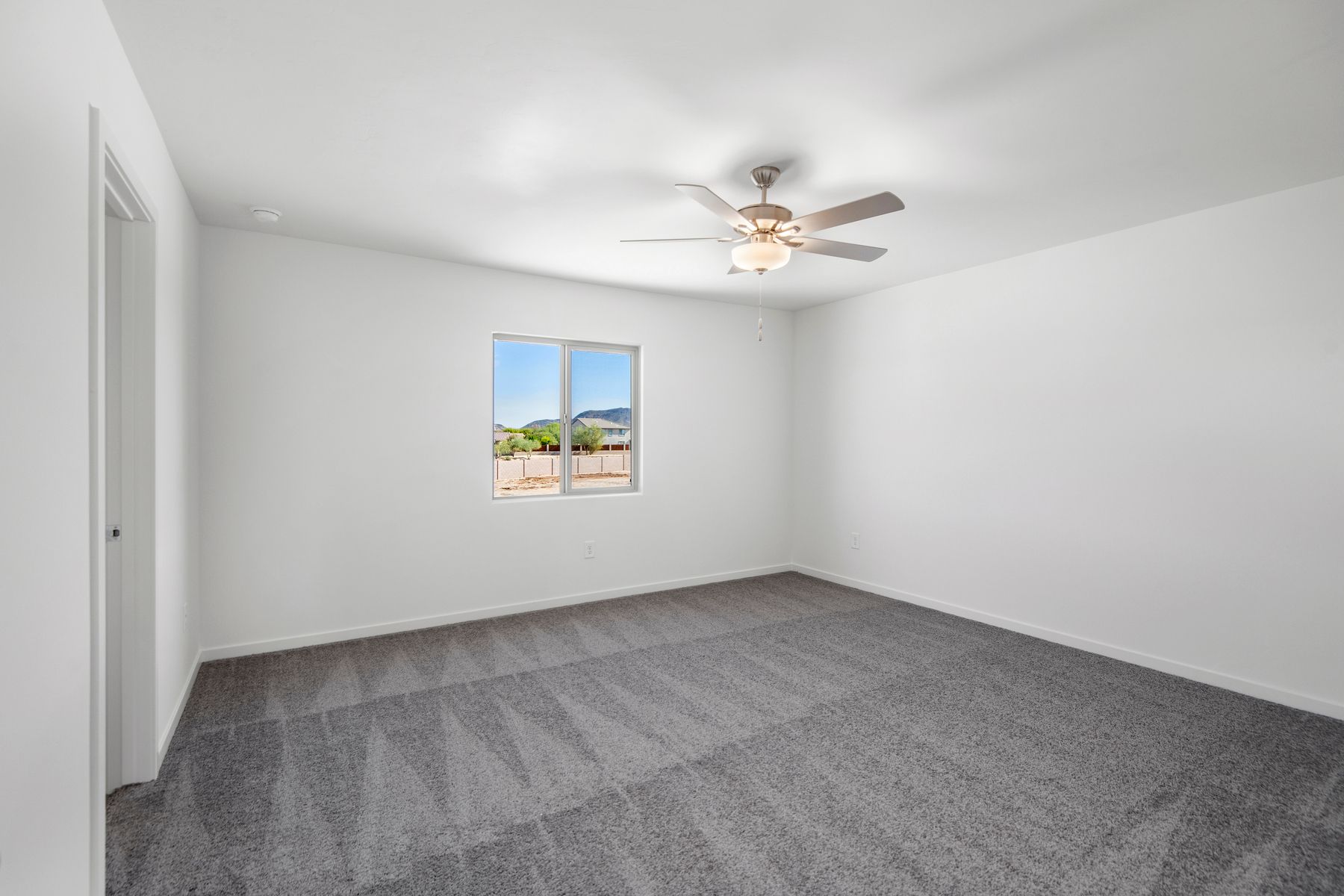 The master suite has beautiful windows that provide natural lighting.