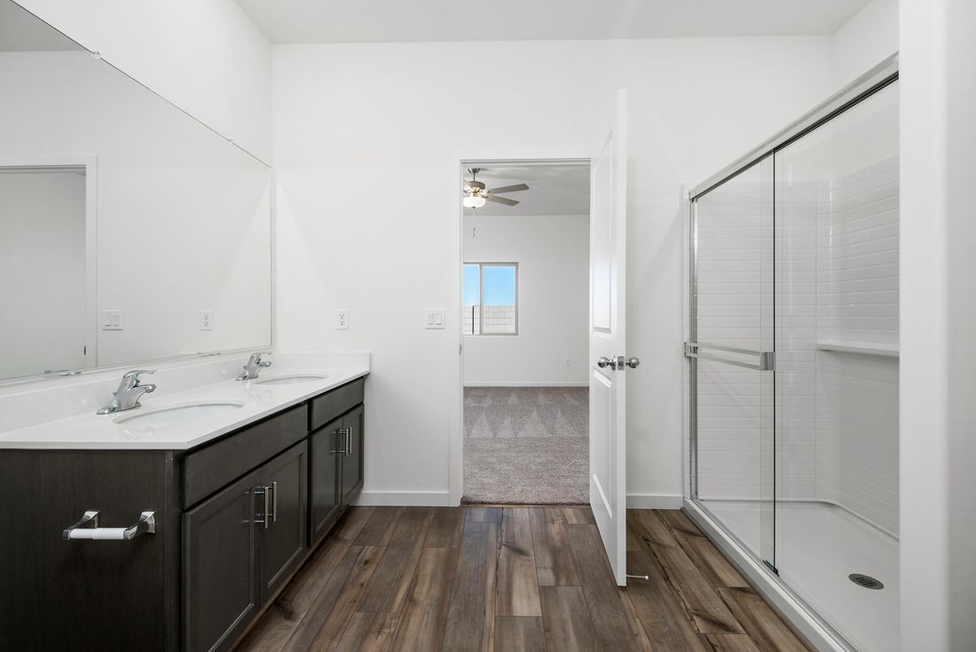 The master bath has a spacious, glass-enclosed shower.
