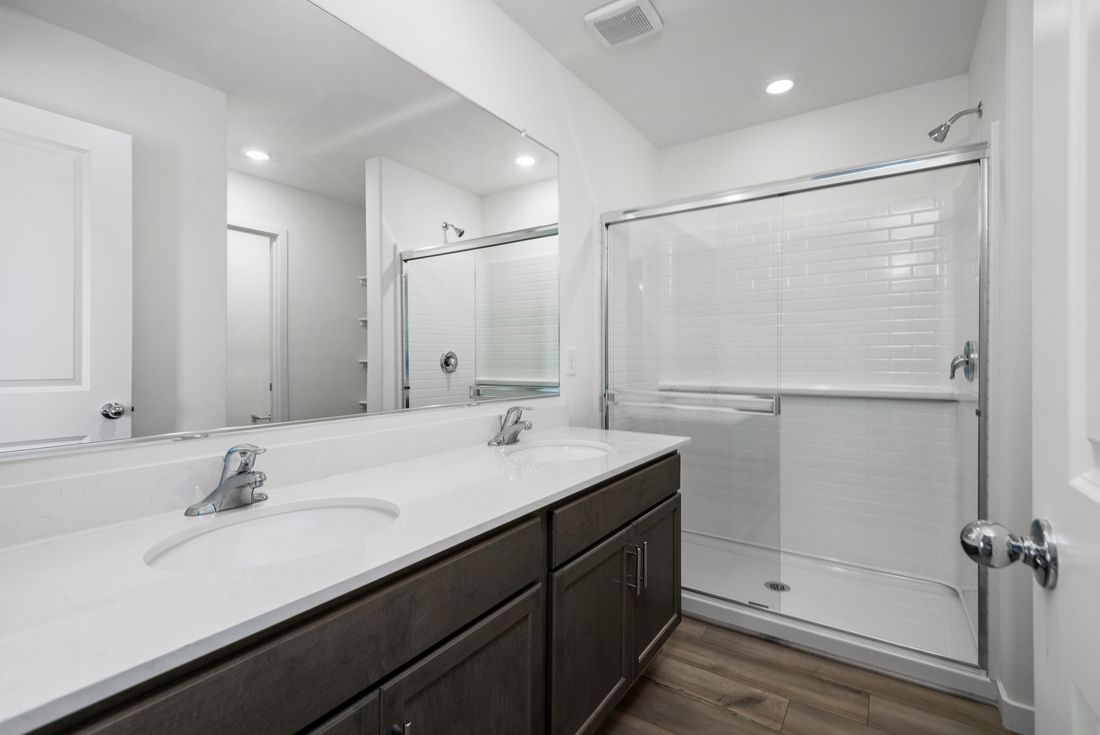 The master bathroom has a spacious walk-in shower.