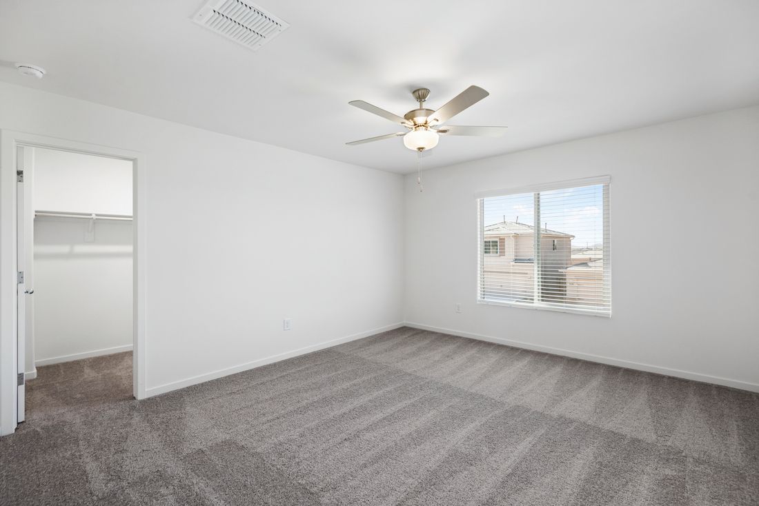 The master bedroom has tons of natural light, bringing a warm atmosphere.