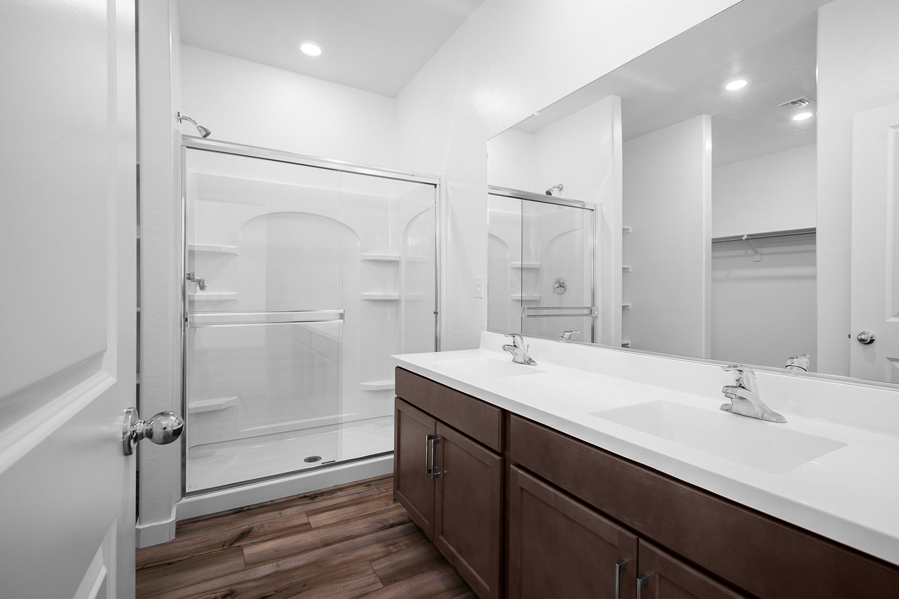 The master bath has a spacious, glass-enclosed shower along with spacious countertops perfect for getting ready.