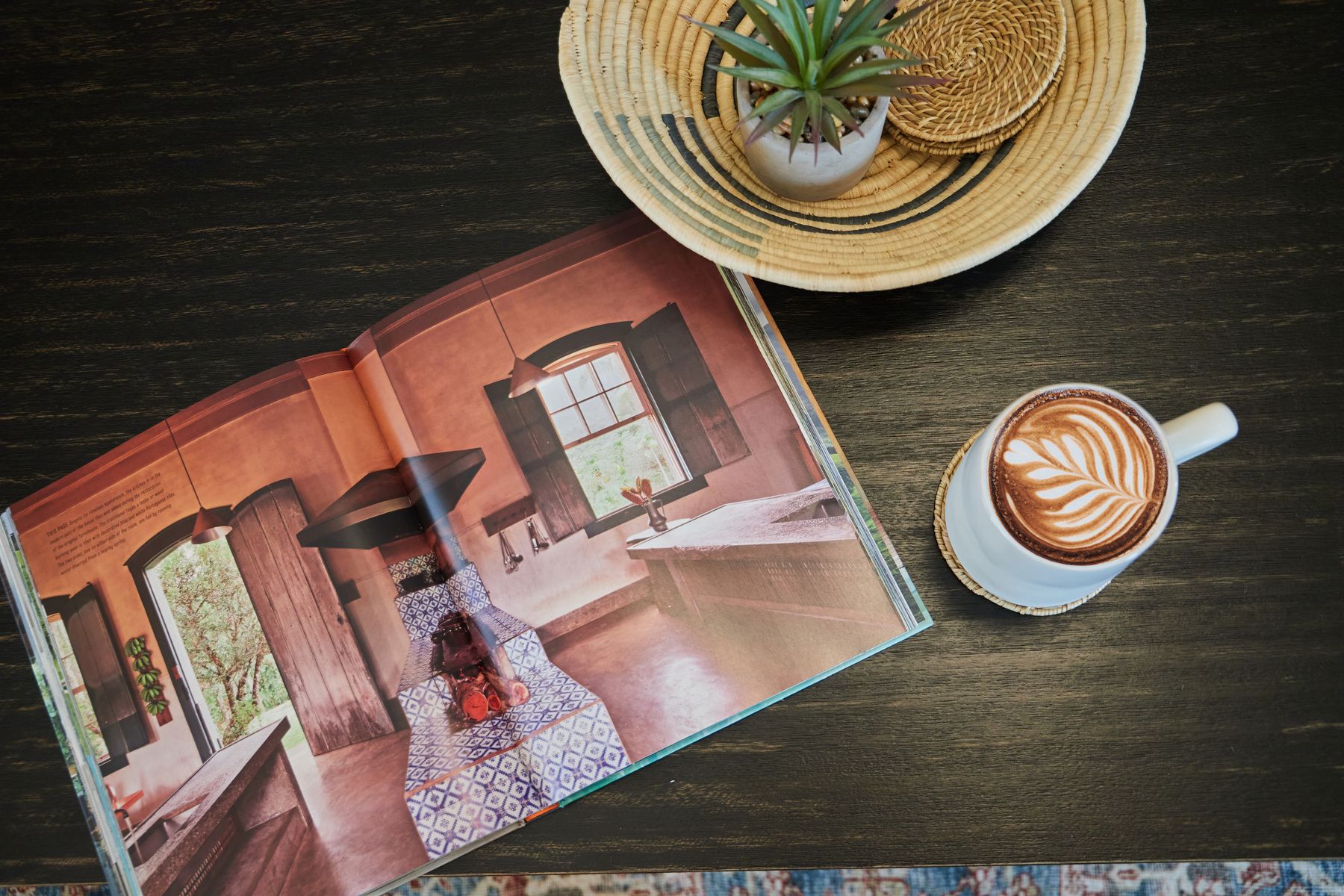 Stock photo detail shot of a wooden table with a cup of coffee and a magazine.