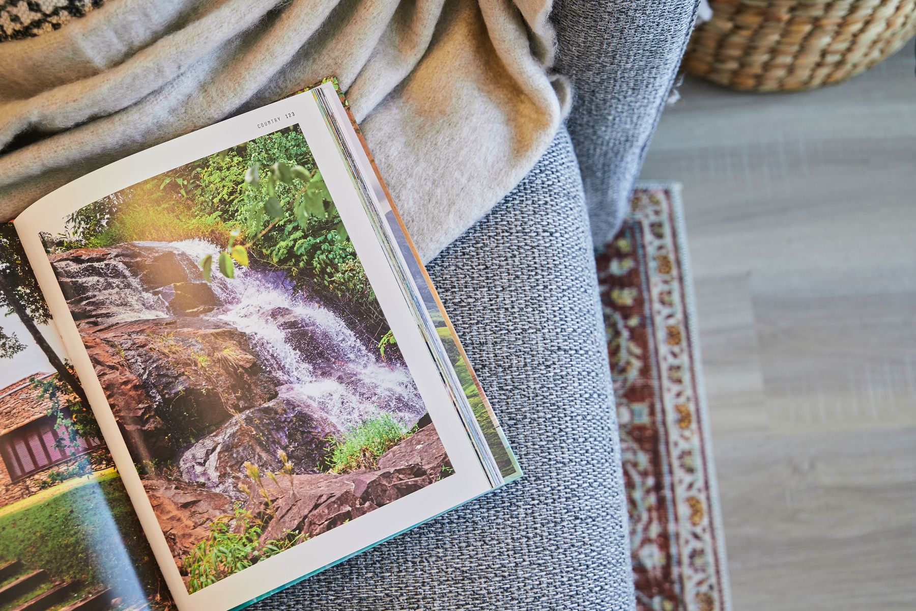 Photo of decorated master bedroom with iron four-post bed with earth tone bedding, a window with drapes, ceiling fan and carpet.