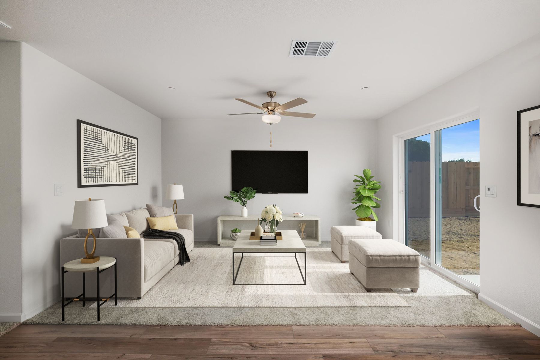 The family room is spacious with a ceiling fan.