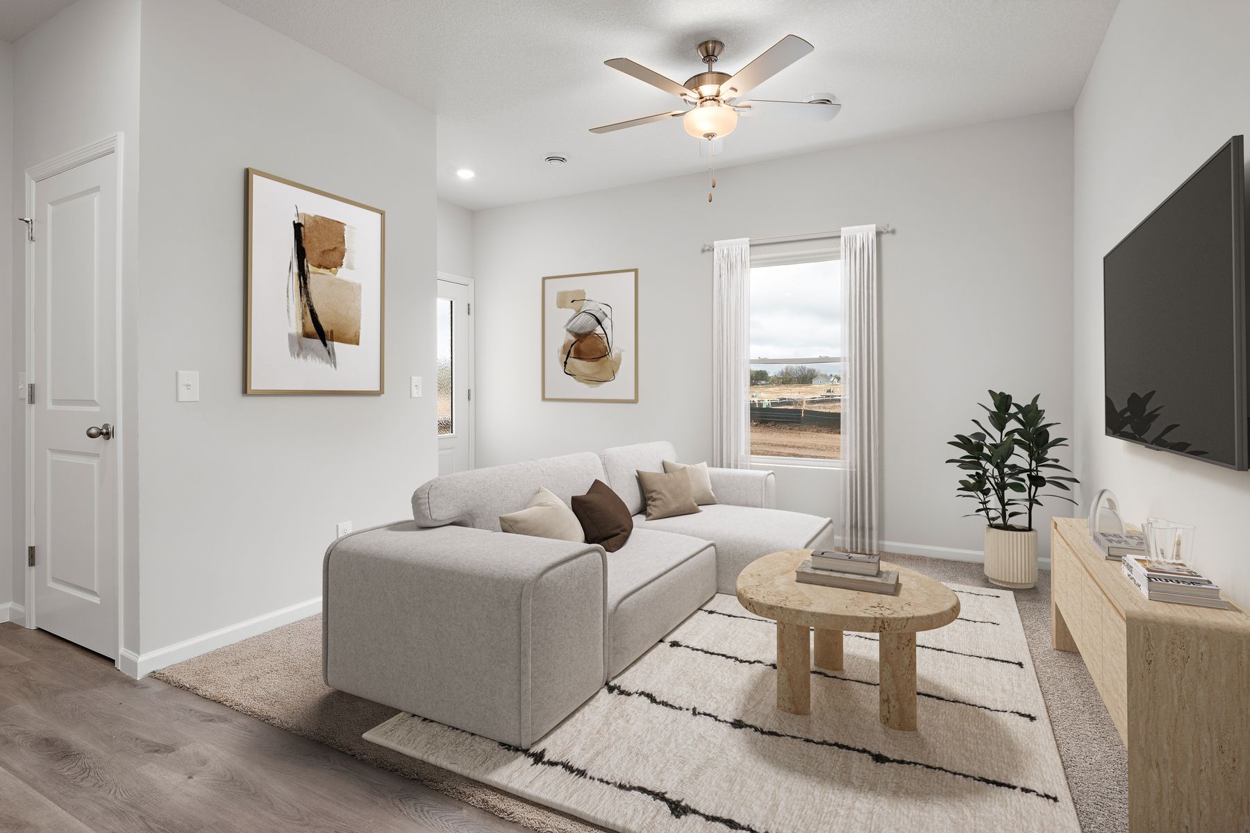 The family room is spacious with a ceiling fan.