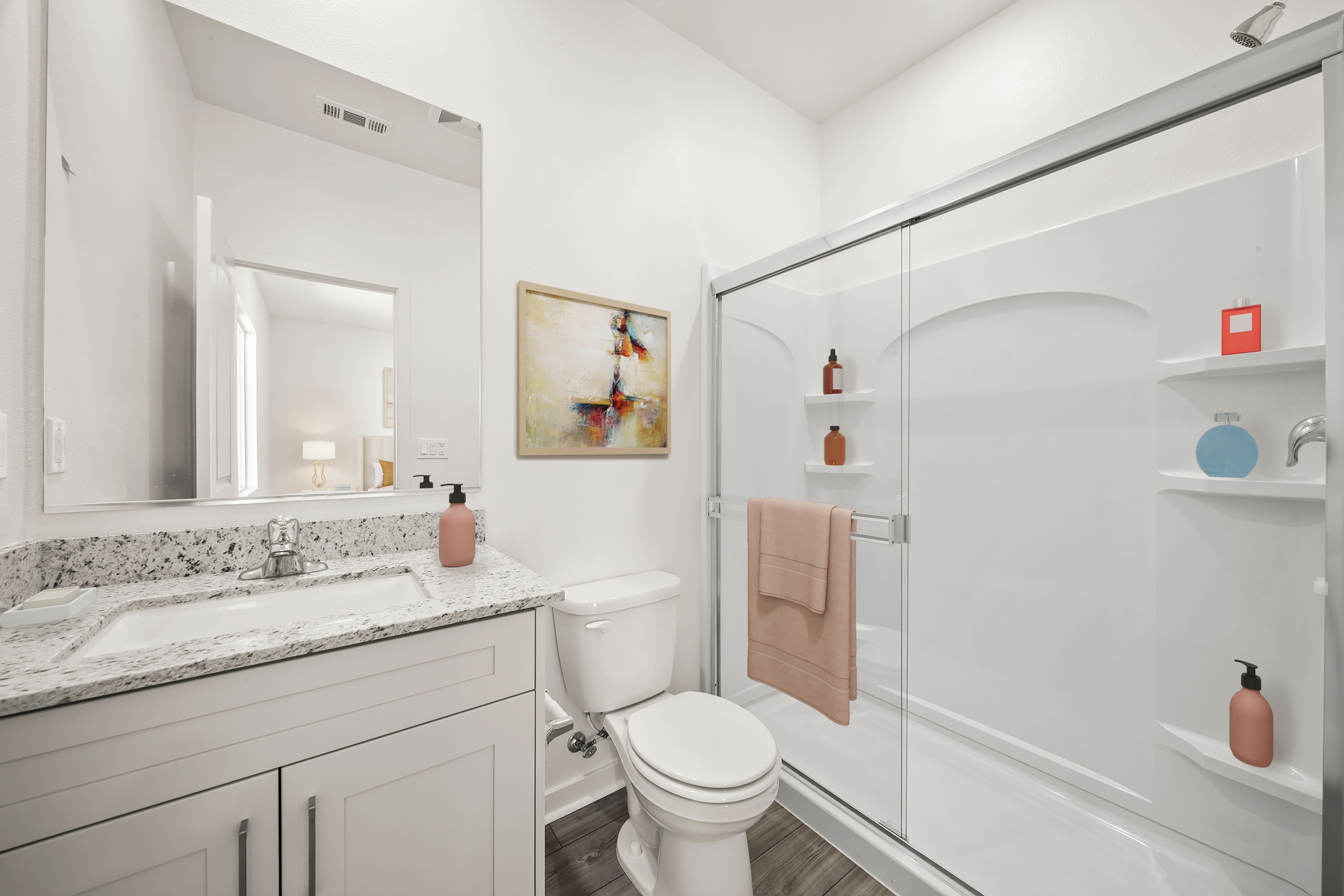 The master bathroom has a large vanity and step in shower.