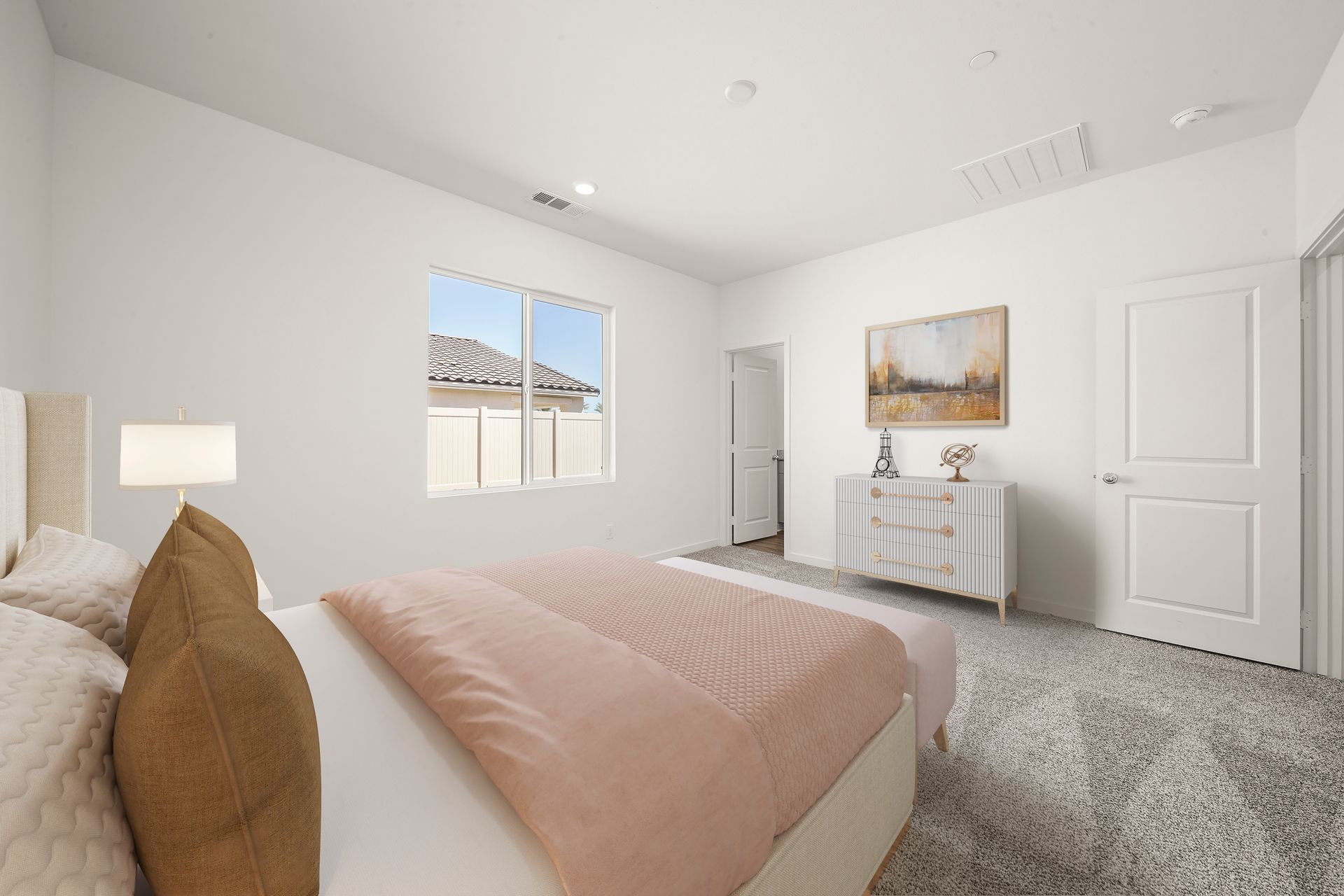 The master bedroom is spacious and has carpet.