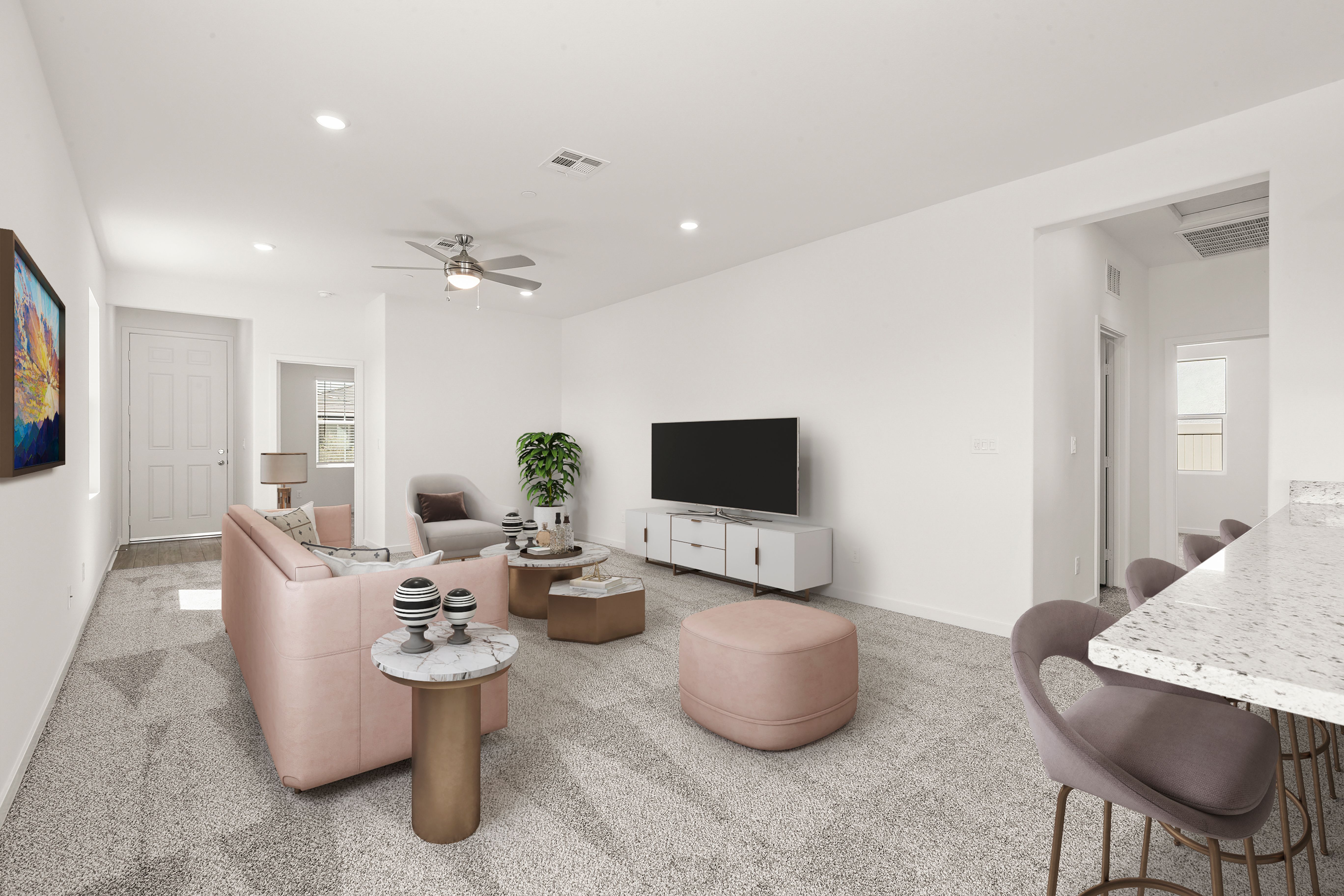 The family room is spacious with a ceiling fan.