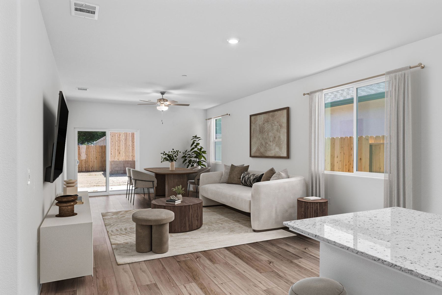 The family room is spacious with a ceiling fan.