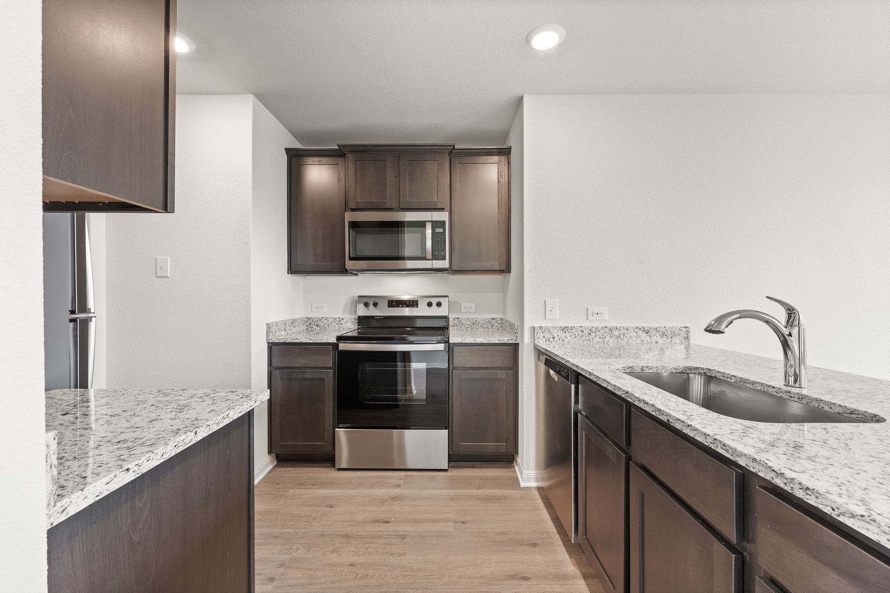 The kitchen of the Amelia has beautiful wood cabinetry.