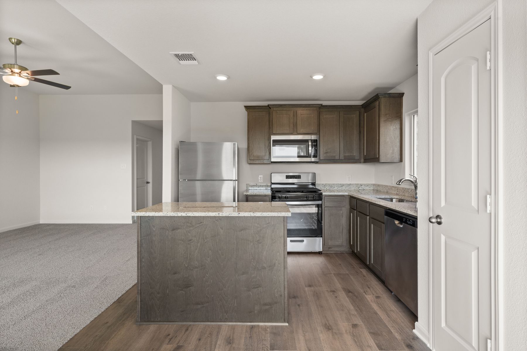 The kitchen has sprawling granite countertops.