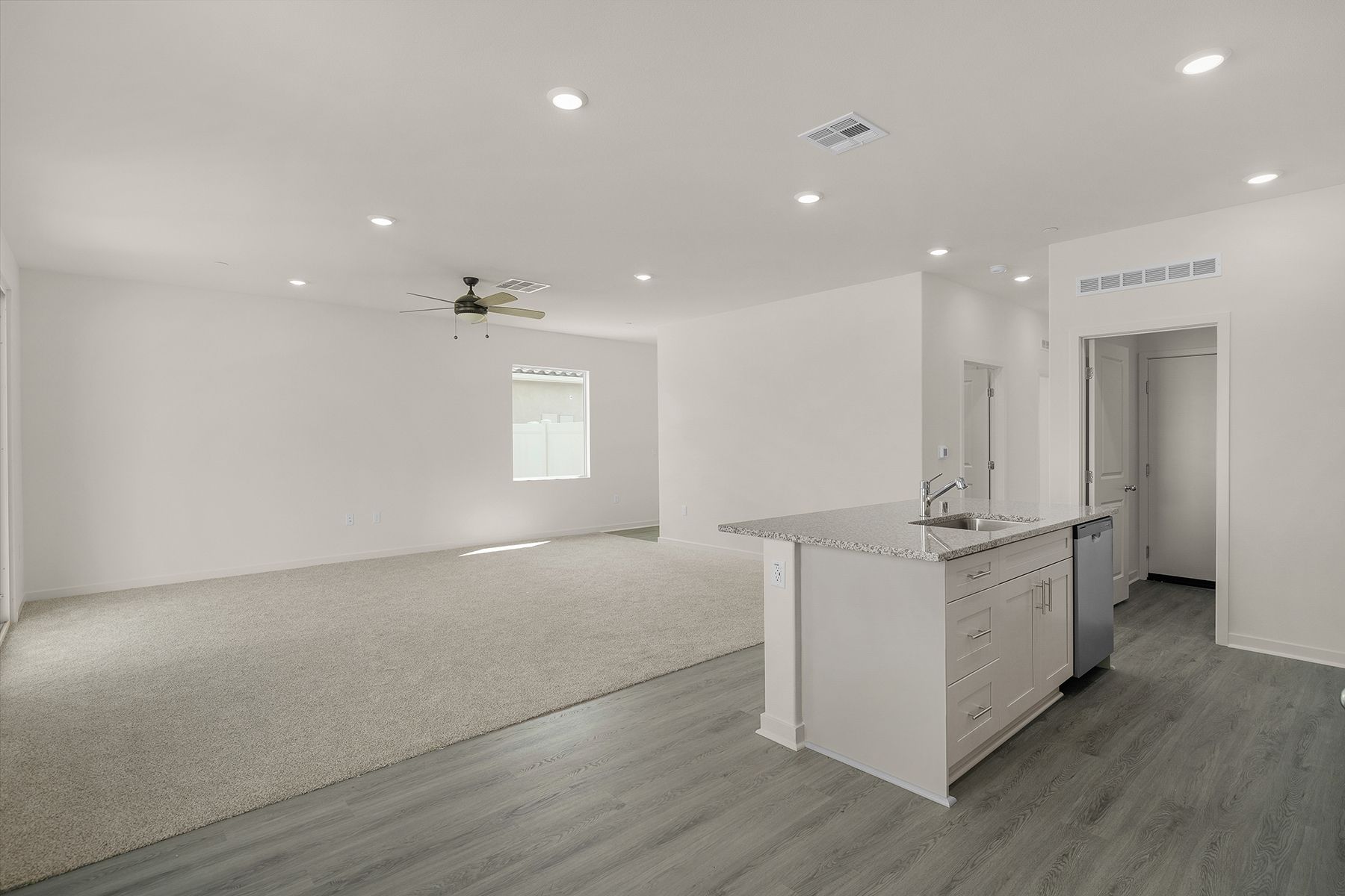 The family room is spacious with a ceiling fan.
