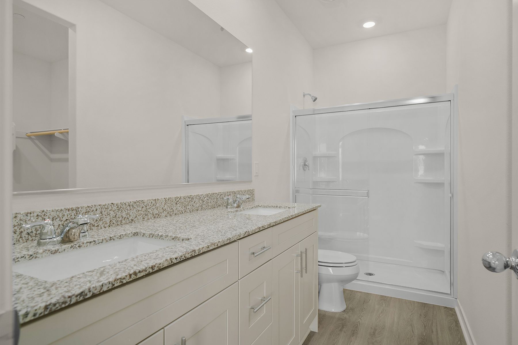The master bathroom has a dual sink vanity and a step in shower.