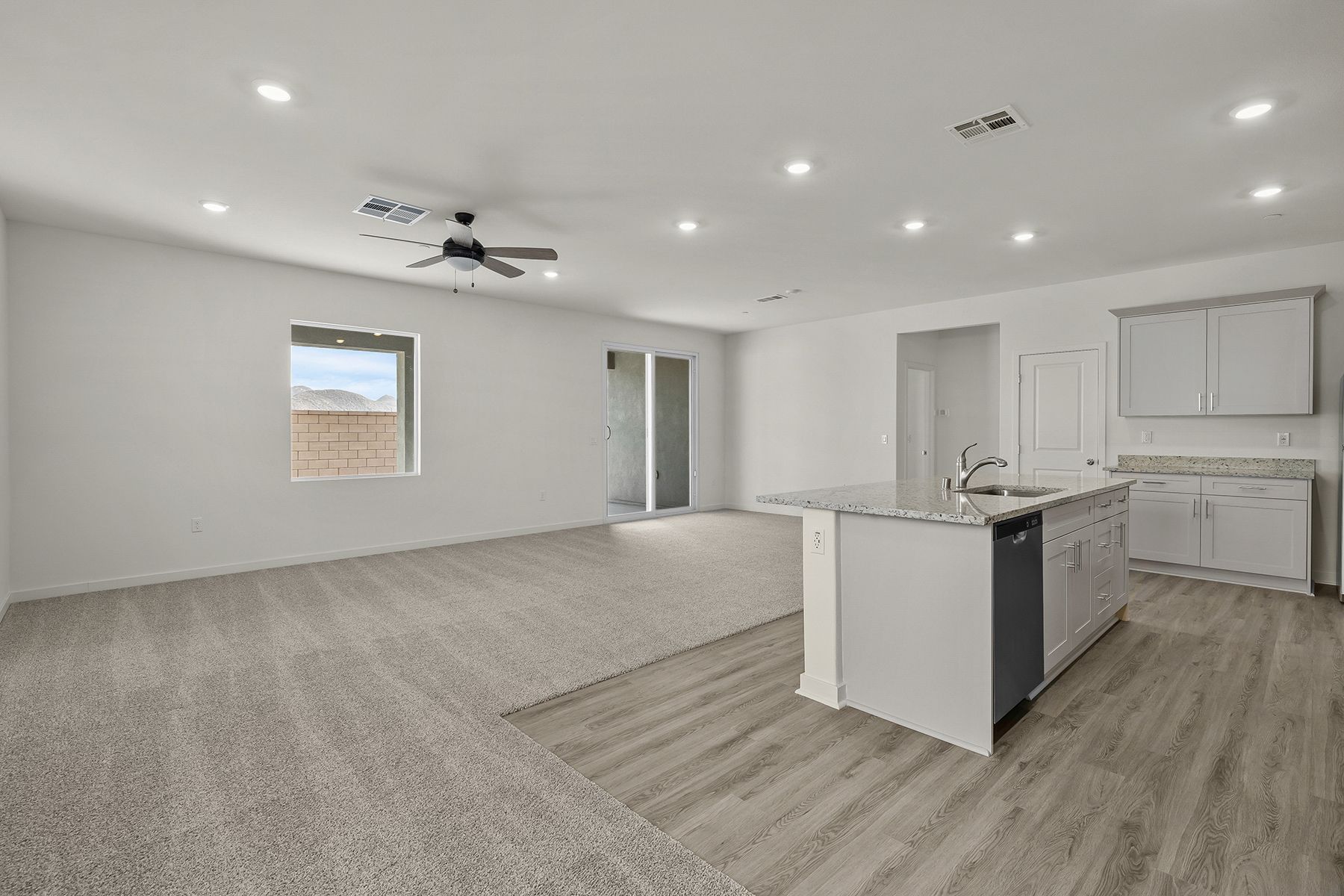 The family room is spacious with a ceiling fan.