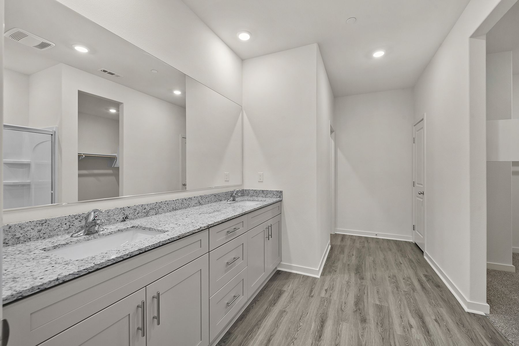 The master bathroom has a dual sink vanity.