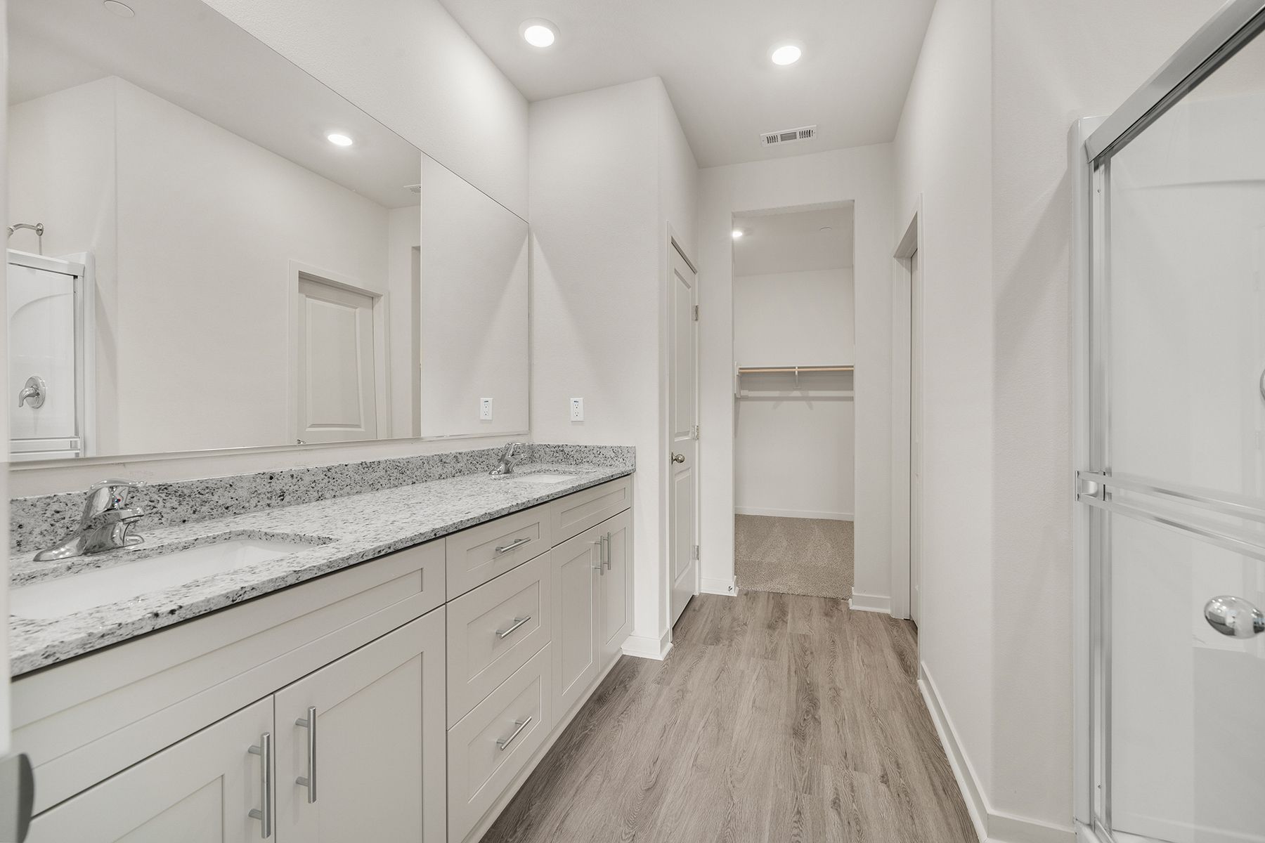 The master bathroom has a dual sink vanity.