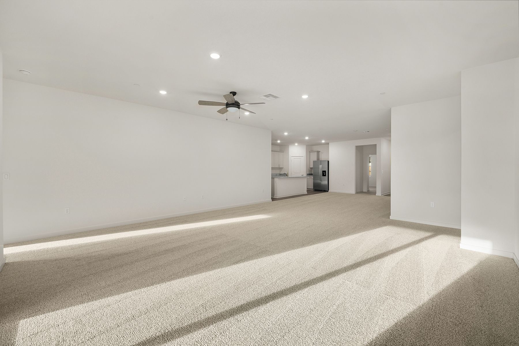 The family room is spacious with a ceiling fan.