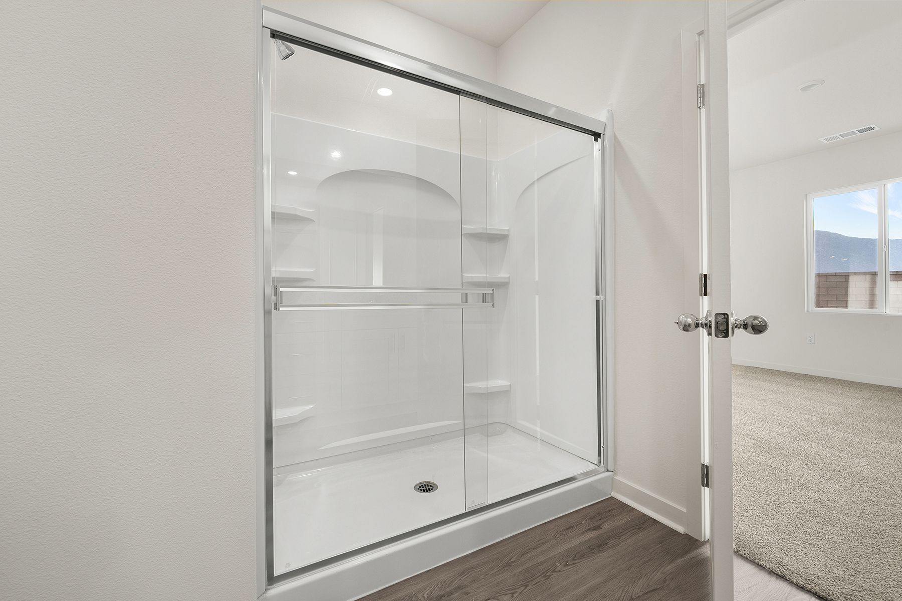 The master bathroom has a step in shower. 